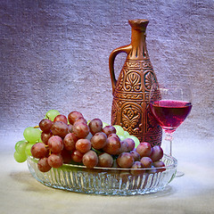 Image showing Still-life with clay bottle, grapes and glass