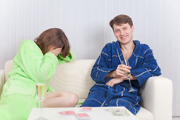 Image showing Girl has lost to the man at a card play and cries