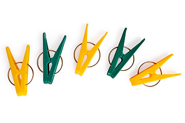 Image showing A number of yellow and green clothespins