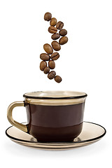 Image showing Brown cup of coffee and steam from the grains