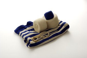 Image showing Blue and white striped knitting with clews