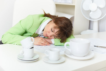 Image showing Office worker has fallen asleep despite drunk by coffee