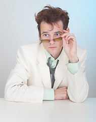 Image showing Man with tousled hair sits at a table