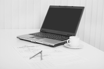 Image showing Desktop of engineer with the laptop and drawing on paper