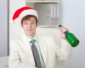 Image showing Businessman cheerfully celebrates Christmas at office