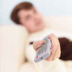 Image showing Man aims in TV the remote control