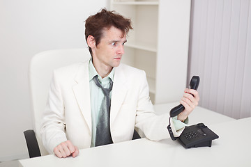 Image showing Businessman has finished difficult telephone conversation