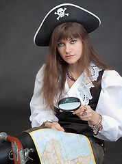 Image showing Woman - sea pirate with a map and magnifier