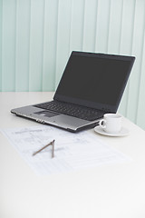 Image showing Laptop on table with drawing and a compasses - business still-li