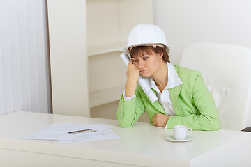 Image showing Woman - construction superintendent sits upset