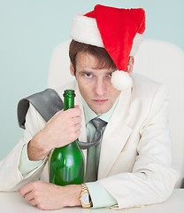 Image showing Drunk and tired guy in white jacket with bottle celebrates Chris