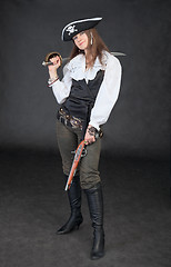 Image showing Young girl in costume of sea pirate with sabre and pistol