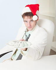 Image showing Person in Christmas hat gives us money