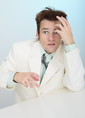 Image showing Young amusing tousled scared person in white jacket