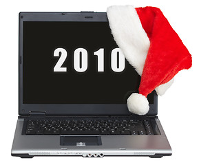 Image showing New Year s laptop with 2010 on screen and santa cap