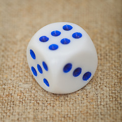 Image showing Plastic dice with blue dots on canvas close up