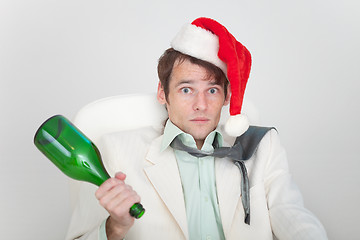 Image showing Drunk businessman has dressed Christmas cap