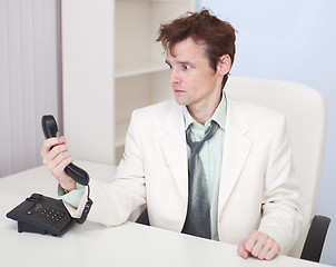 Image showing Young man has finished conversation with chief at office