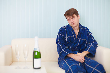 Image showing person in expectation of woman with sparkling wine on sofa
