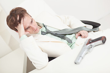 Image showing Depressed businessman to prepare for kill oneself