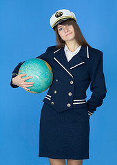 Image showing Woman in sea uniform with globe