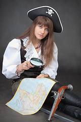 Image showing Woman - pirate with sea map and magnifier glass