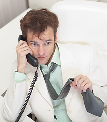 Image showing Men worries speaking by phone with chief