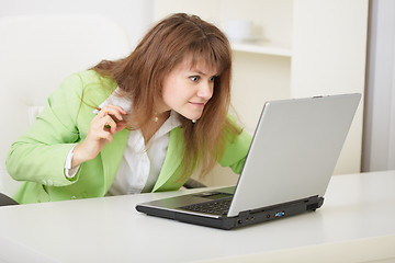 Image showing Girl threateningly looks at the computer monitor