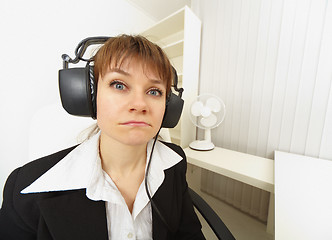 Image showing Comical girl in big stereos ear-phones
