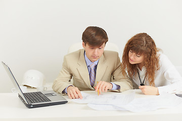 Image showing Two young businessmen work with documents