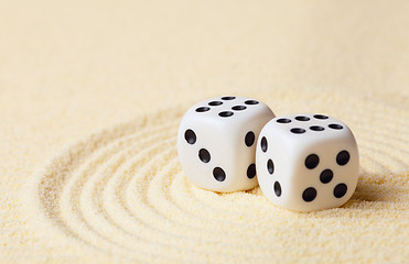 Image showing Dices on sand in rock garden