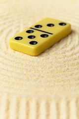 Image showing Domino on yellow sand - art miniature