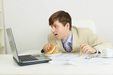 Image showing Funny man with big sandwich at office