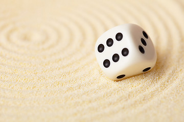 Image showing Dice on sand in rock garden