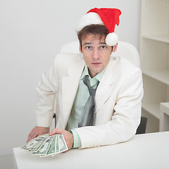 Image showing Young man with christmas hat and premium
