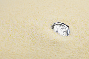 Image showing Ancient mechanical watch in sand