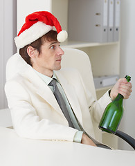 Image showing Young drunkard celebrates new year with wine bottle