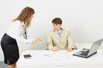 Image showing Woman secretary delivered to businessman a hamburger
