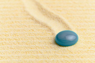 Image showing Abstract composition - sandy surface and blue glass drop