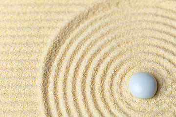 Image showing White drop on surface of yellow sand - abstract background