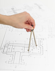 Image showing Hand of engineer with compasses - work with drawings