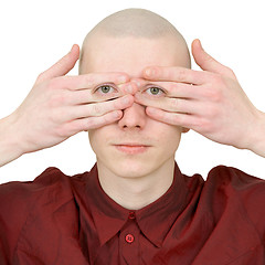 Image showing Person looks covered eyes palms