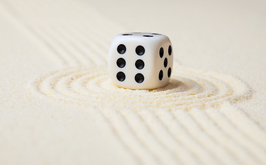 Image showing Dice on sand in rock garden