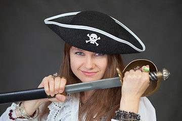Image showing Young woman pirate gets a sabre from sheath