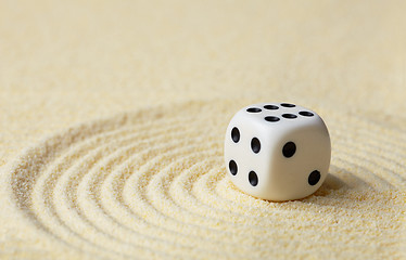 Image showing Dice with against yellow sand