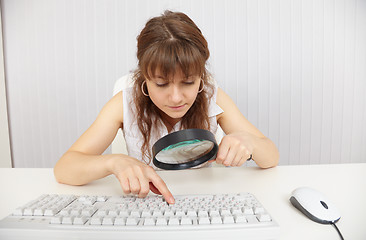 Image showing Young blind woman works with keyboard by means of magnifier