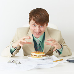 Image showing Happy person is going to eat on workplace