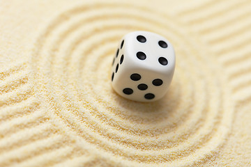 Image showing Dice on sand surface - abstract art composition