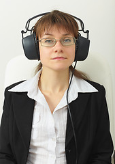 Image showing Tired woman - sound technician with professional stereos ear-pho