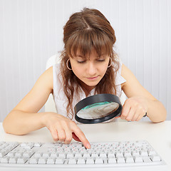 Image showing Girl with poor eyesight works with computer keyboard